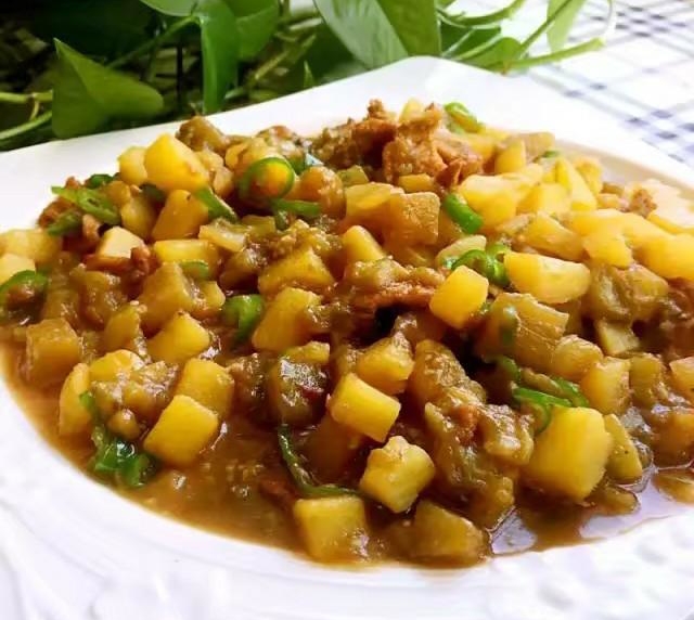 Stewed Eggplant in a plate , eggplant and potato pieces mix together