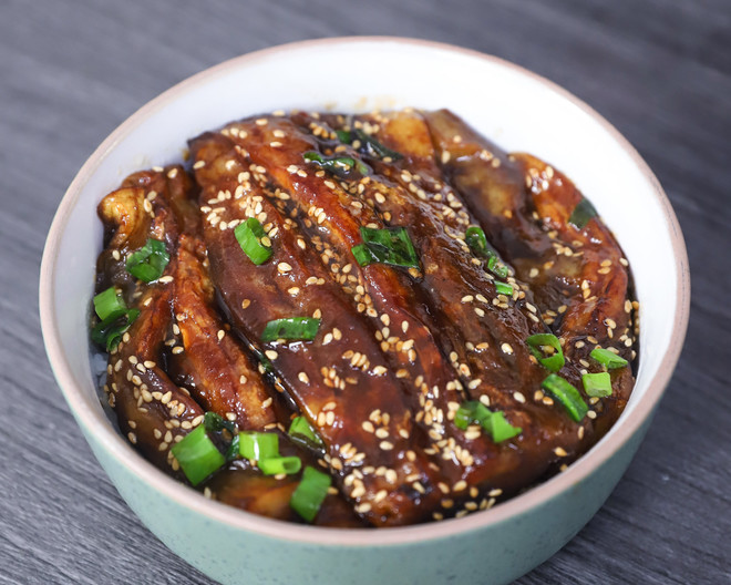 braised eggplant in a bowl with green onion