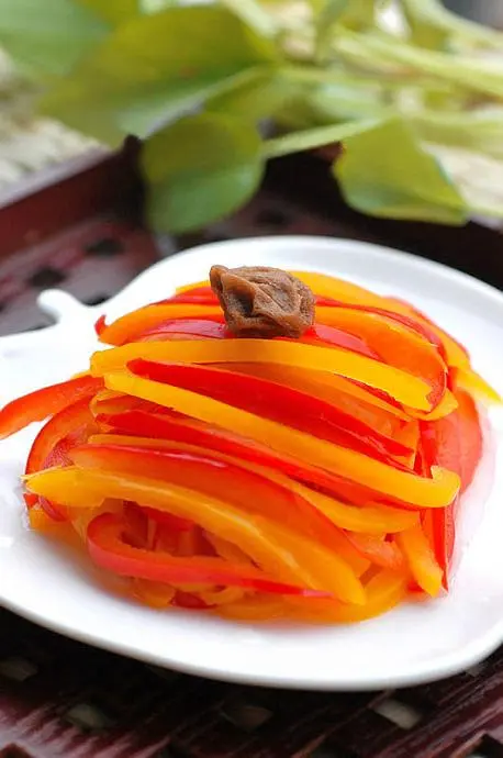 dish of red and yellow bell pepper stripe with one Preserved Plum