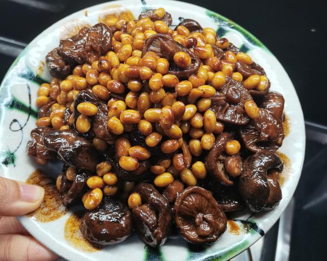 Braised soybean with mushrooms on a plate, some shiitake mushrooms mix with yellow soybeans