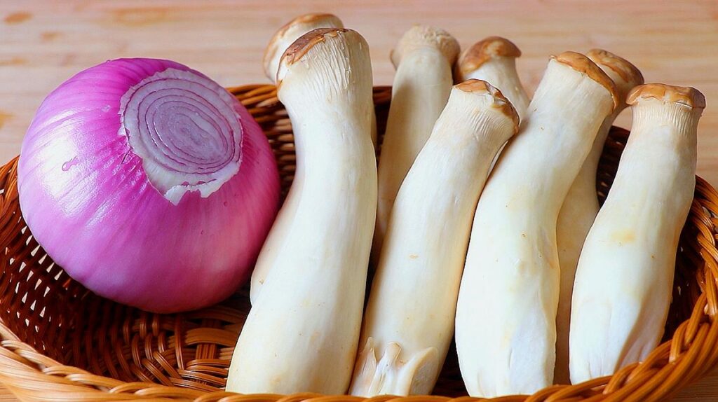 some King oyster mushrooms with an onion