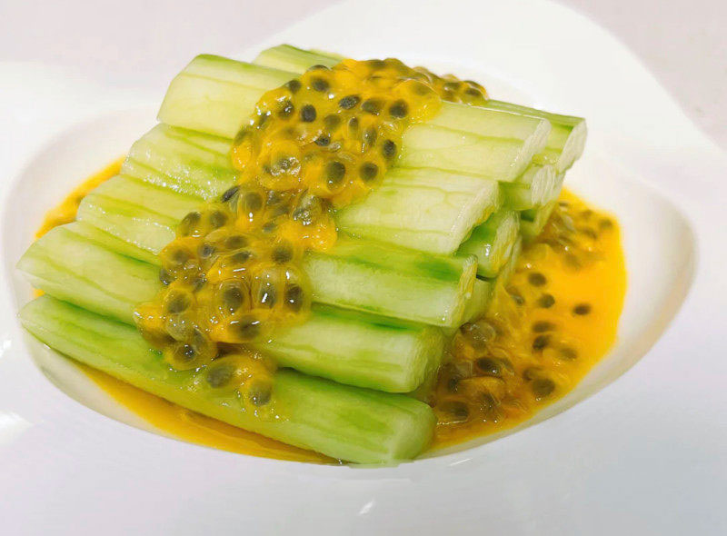 Passion fruit cucumber salad, cucumber strips with passion fruit in a white plate