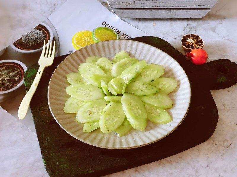 cucumber salad with black pepper in a white plate 