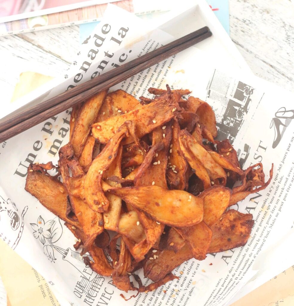  grilled king oyster mushroom slices with chopsticks