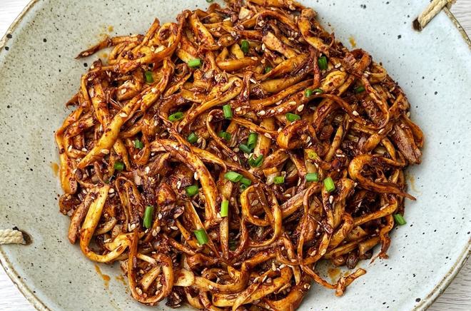 1 plate of king oyster mushroom stir fry with some chopped green onion