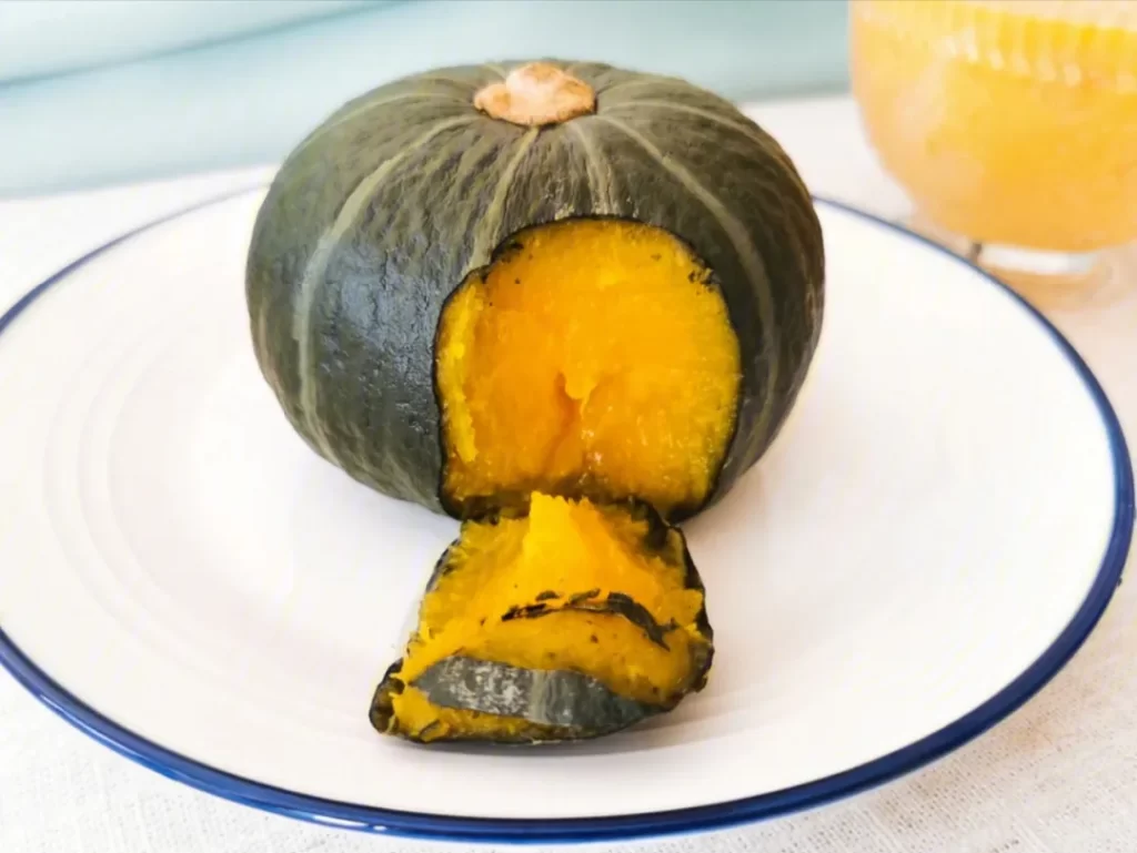 a small pumpkin with green skin on a plate